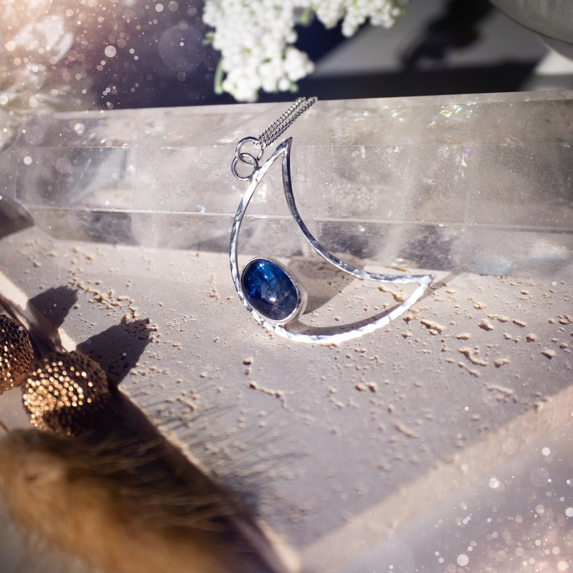 Royal Blue Kyanite moon necklace made from sterling silver and fine silver. The moon has been hammered for a sparkling effect. Beautiful gift for crystal and moon lovers. Celestial jewellery which has been handmade with love and care.