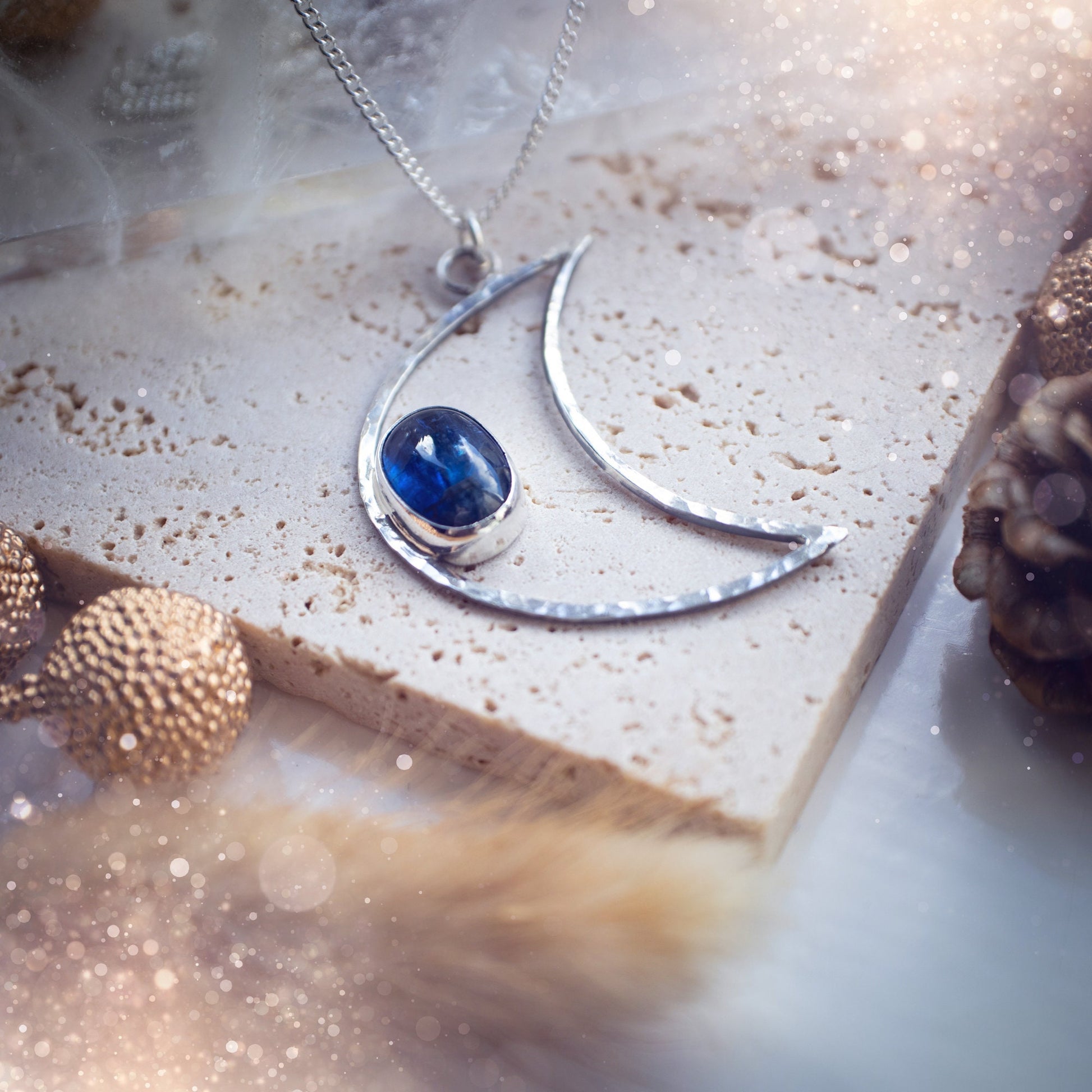 Royal Blue Kyanite moon necklace made from sterling silver and fine silver. The moon has been hammered for a sparkling effect. Beautiful gift for crystal and moon lovers. Celestial jewellery which has been handmade with love and care.