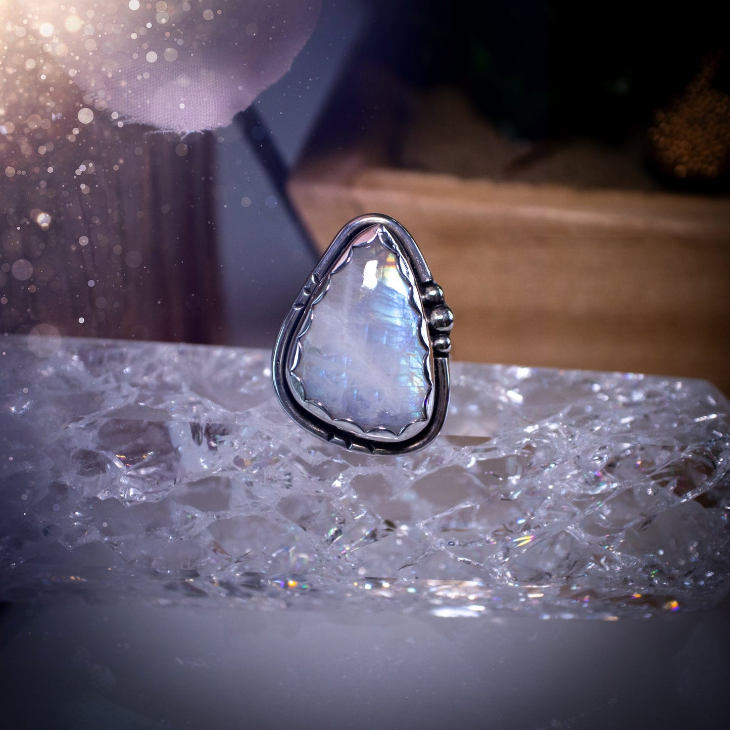 Beautiful Rainbow Moonstone ring set in fine and sterling silver. Featuring a scallop bezel, stars on the ring shank and silver accents. Size P