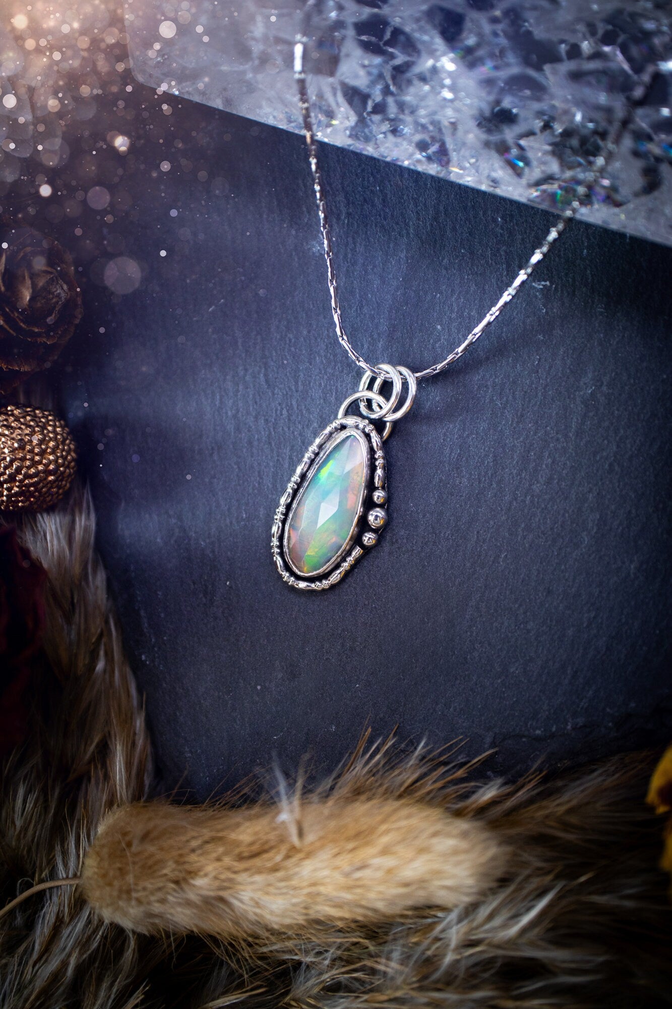 Flashy, natural, rose cut Ethiopian Welo Opal pendant necklace. This beautiful piece of jewellery is hand made, and has been created out of sterling silver. Accompanying this crystal is silver ball and wire components, making an ideal gift for hippys