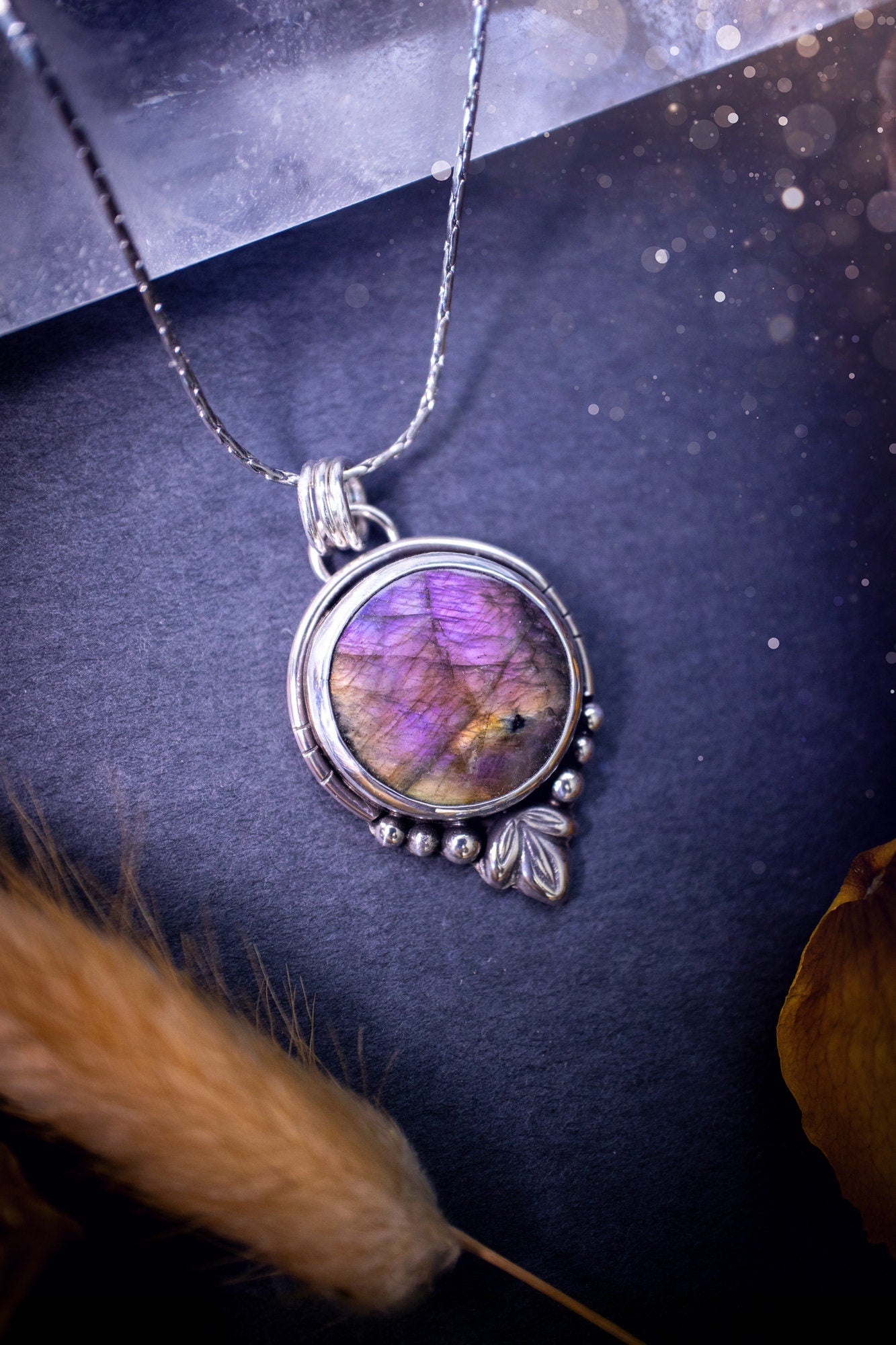 Beautiful and handmade, natural pink, purple and orange labradorite, crystal pendant necklace. This necklace has been made from fine and sterling silver and features silver leaf and ball components. The ideal gift for crystal lovers. Hippy, gothic.