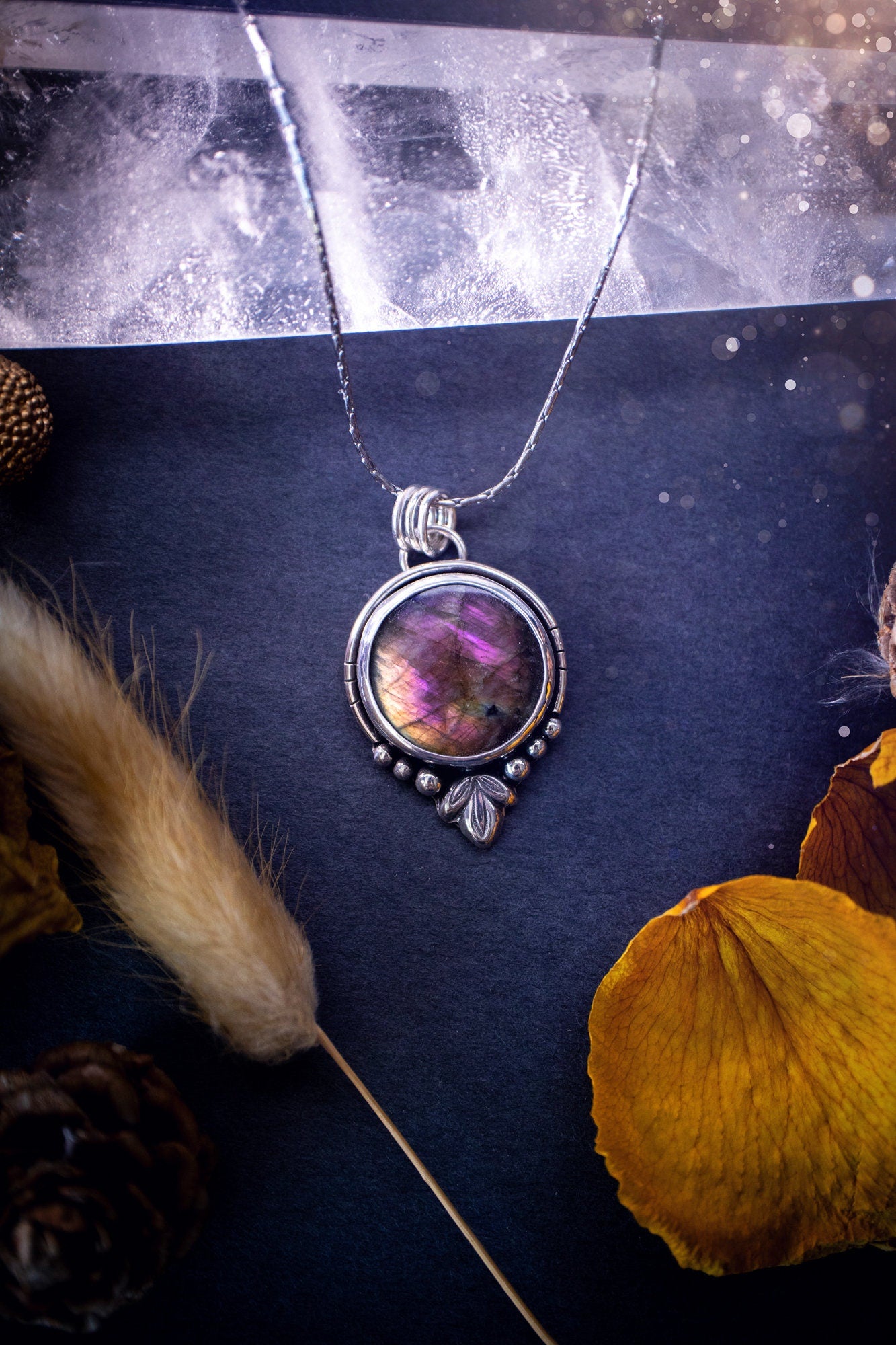 Beautiful and handmade, natural pink, purple and orange labradorite, crystal pendant necklace. This necklace has been made from fine and sterling silver and features silver leaf and ball components. The ideal gift for crystal lovers. Hippy, gothic.