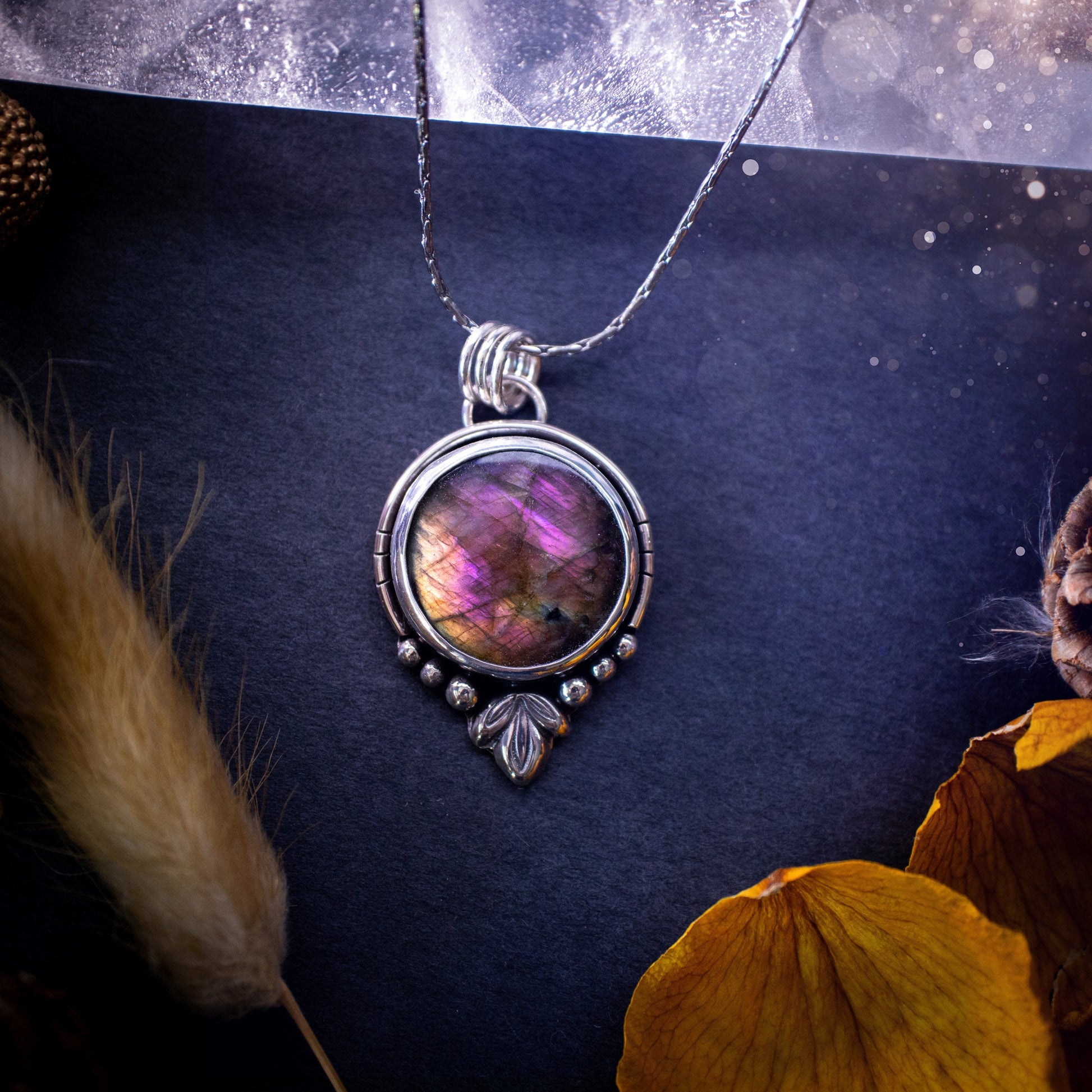 Beautiful and handmade, natural pink, purple and orange labradorite, crystal pendant necklace. This necklace has been made from fine and sterling silver and features silver leaf and ball components. The ideal gift for crystal lovers. Hippy, gothic.