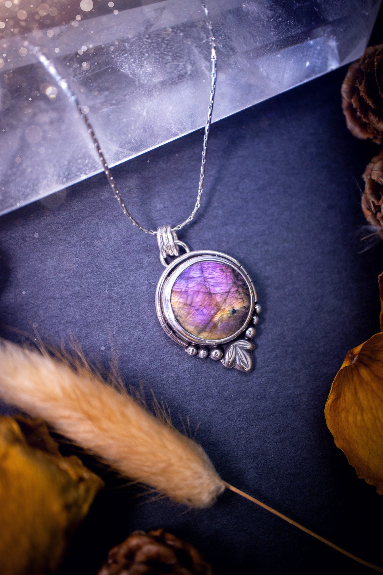 Beautiful and handmade, natural pink, purple and orange labradorite, crystal pendant necklace. This necklace has been made from fine and sterling silver and features silver leaf and ball components. The ideal gift for crystal lovers. Hippy, gothic.