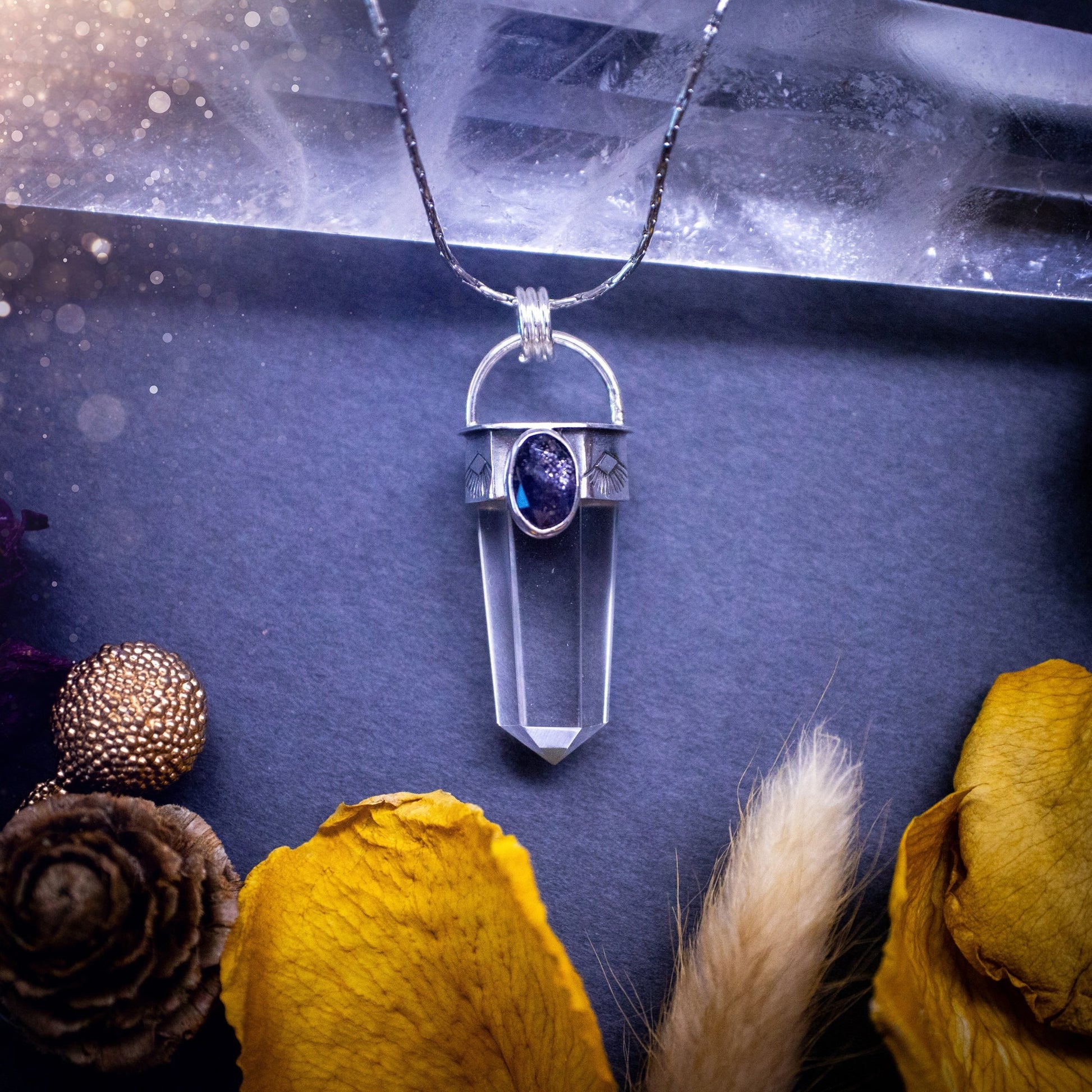 Beautiful, handmade Iolite and quartz crystal point pendant necklace. This pendant is a statement and has been handcrafted out of recycled fine and sterling silver. Featuring southwest stamp detail along the bezel. Ideal for crystal lovers, gothic.