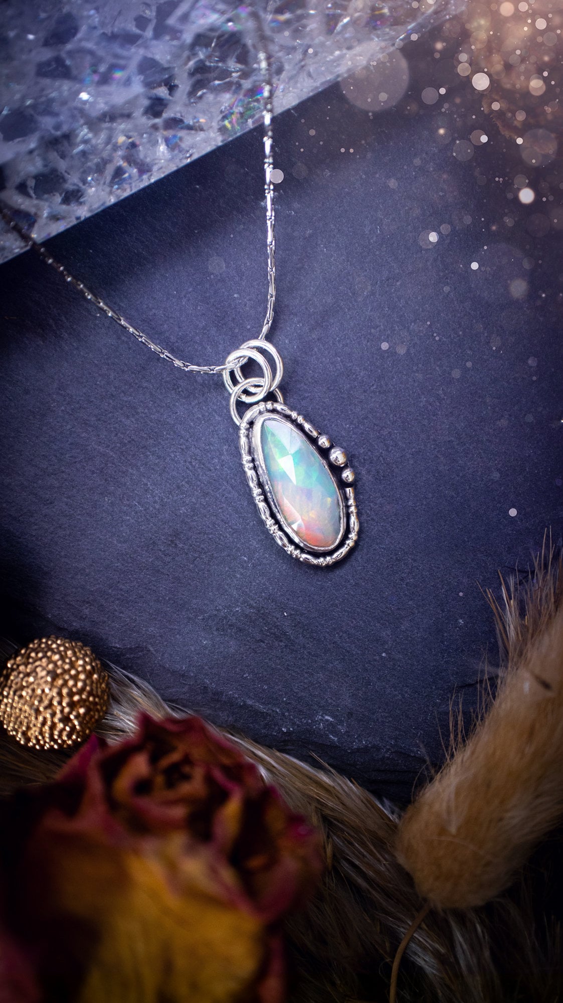 Flashy, natural, rose cut Ethiopian Welo Opal pendant necklace. This beautiful piece of jewellery is hand made, and has been created out of sterling silver. Accompanying this crystal is silver ball and wire components, making an ideal gift for hippys