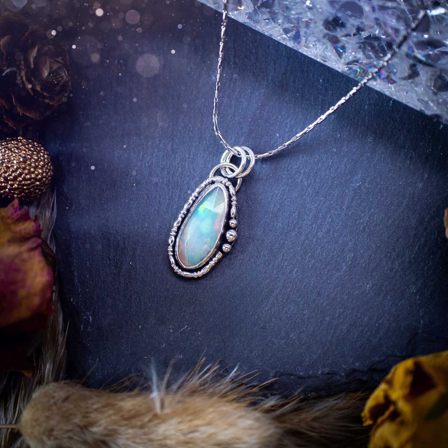 Flashy, natural, rose cut Ethiopian Welo Opal pendant necklace. This beautiful piece of jewellery is hand made, and has been created out of sterling silver. Accompanying this crystal is silver ball and wire components, making an ideal gift for hippys