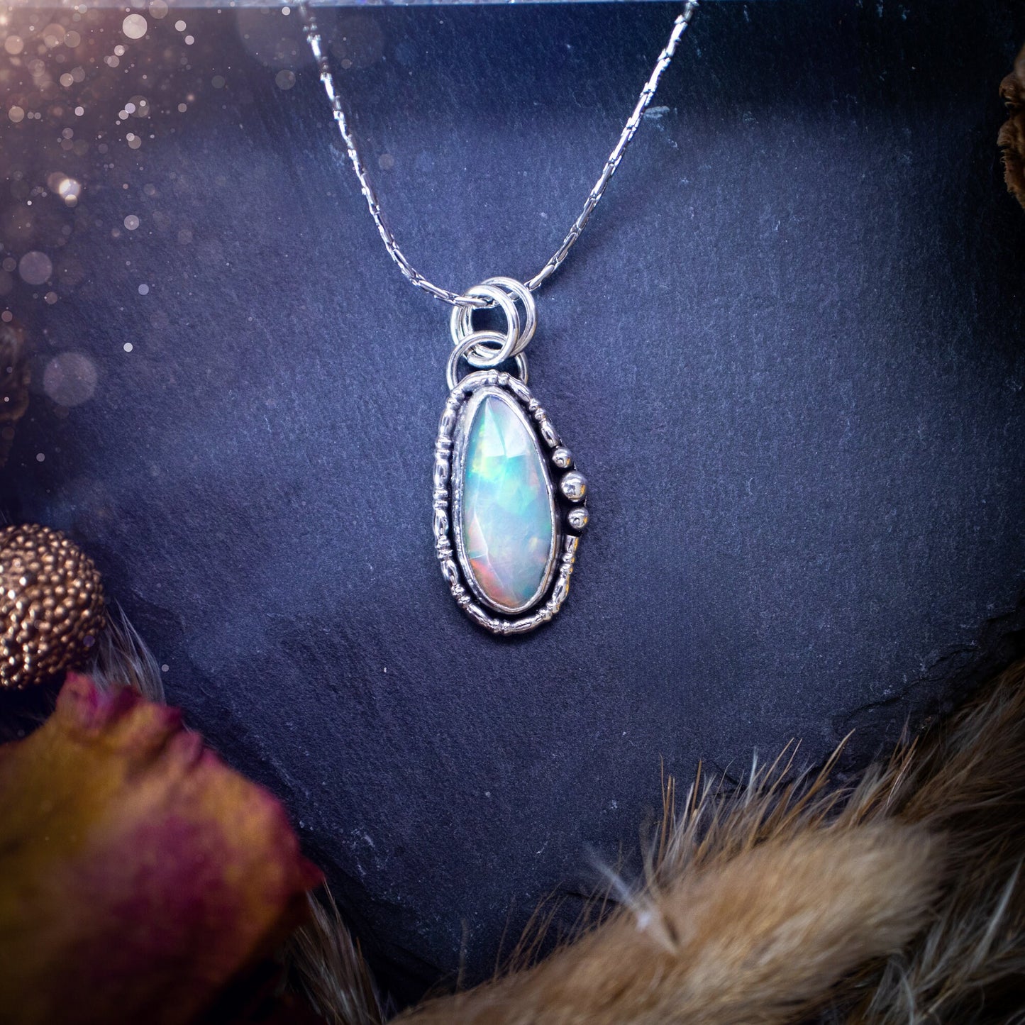 Flashy, natural, rose cut Ethiopian Welo Opal pendant necklace. This beautiful piece of jewellery is hand made, and has been created out of sterling silver. Accompanying this crystal is silver ball and wire components, making an ideal gift for hippys