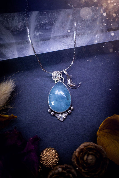 Bold and beautiful, blue aquamarine crystal pendant necklace. This pendant has been handcrafted out of fine and sterling silver. The piece also has a little moon charm. Suitable for jewellery gifts. Gothic, hippy and ideal for her. March birthstone