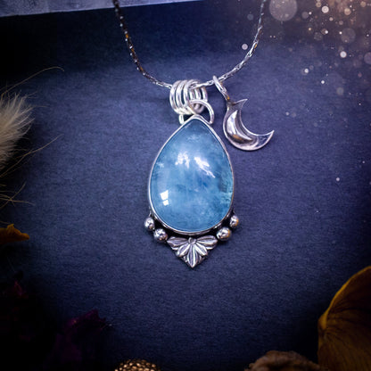 Bold and beautiful, blue aquamarine crystal pendant necklace. This pendant has been handcrafted out of fine and sterling silver. The piece also has a little moon charm. Suitable for jewellery gifts. Gothic, hippy and ideal for her. March birthstone