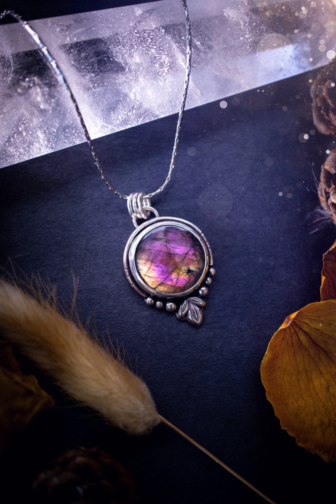 Beautiful and handmade, natural pink, purple and orange labradorite, crystal pendant necklace. This necklace has been made from fine and sterling silver and features silver leaf and ball components. The ideal gift for crystal lovers. Hippy, gothic.