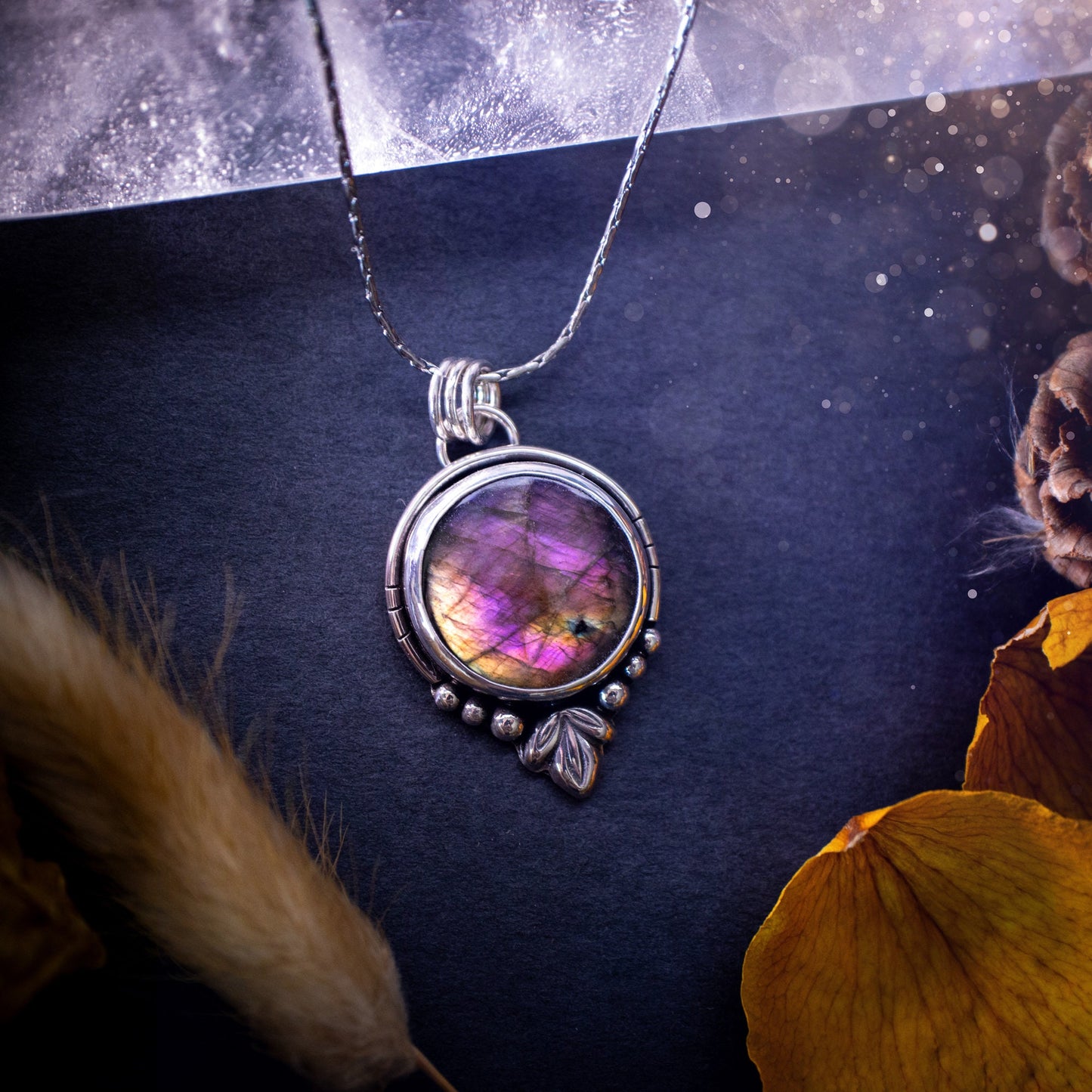 Beautiful and handmade, natural pink, purple and orange labradorite, crystal pendant necklace. This necklace has been made from fine and sterling silver and features silver leaf and ball components. The ideal gift for crystal lovers. Hippy, gothic.