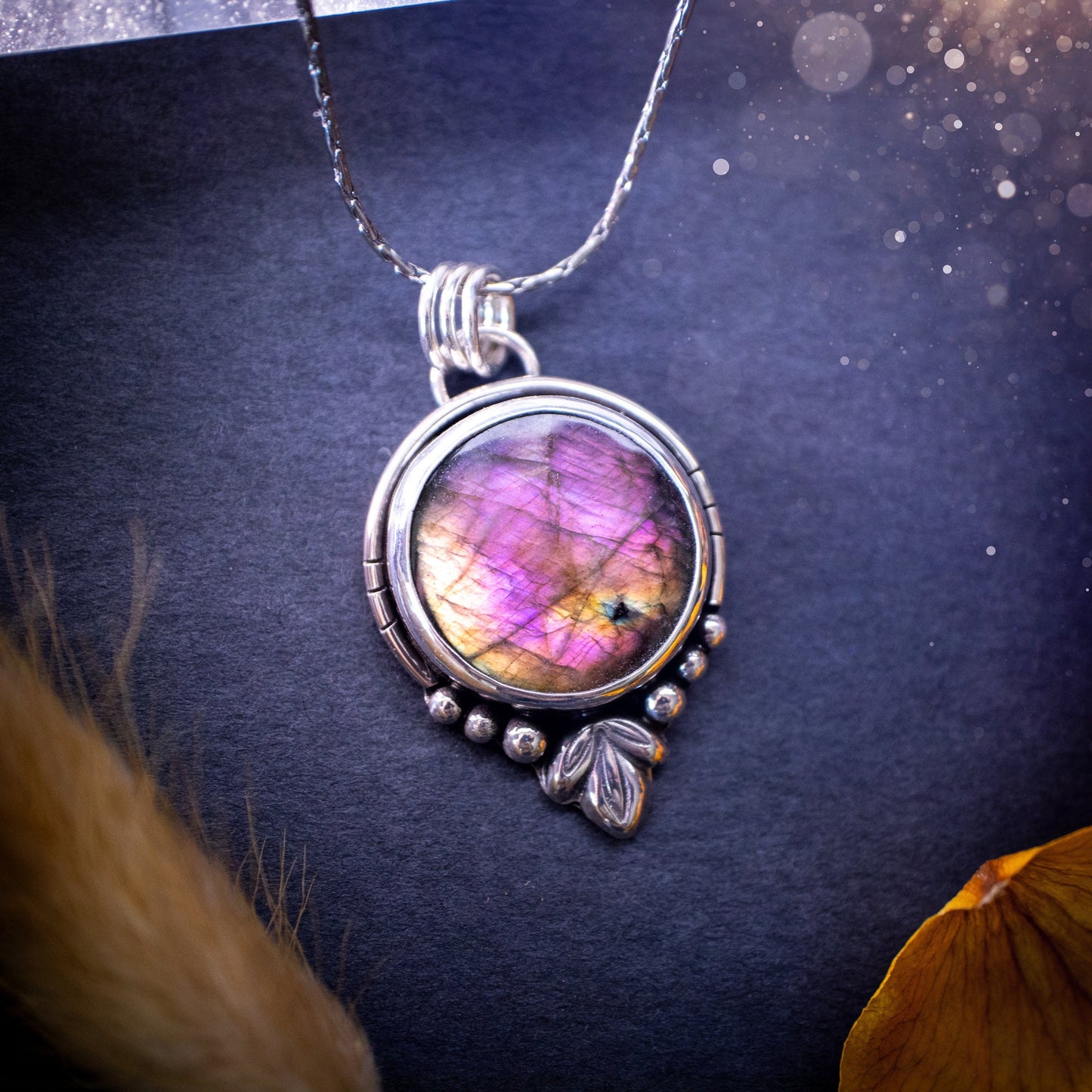 Beautiful and handmade, natural pink, purple and orange labradorite, crystal pendant necklace. This necklace has been made from fine and sterling silver and features silver leaf and ball components. The ideal gift for crystal lovers. Hippy, gothic.