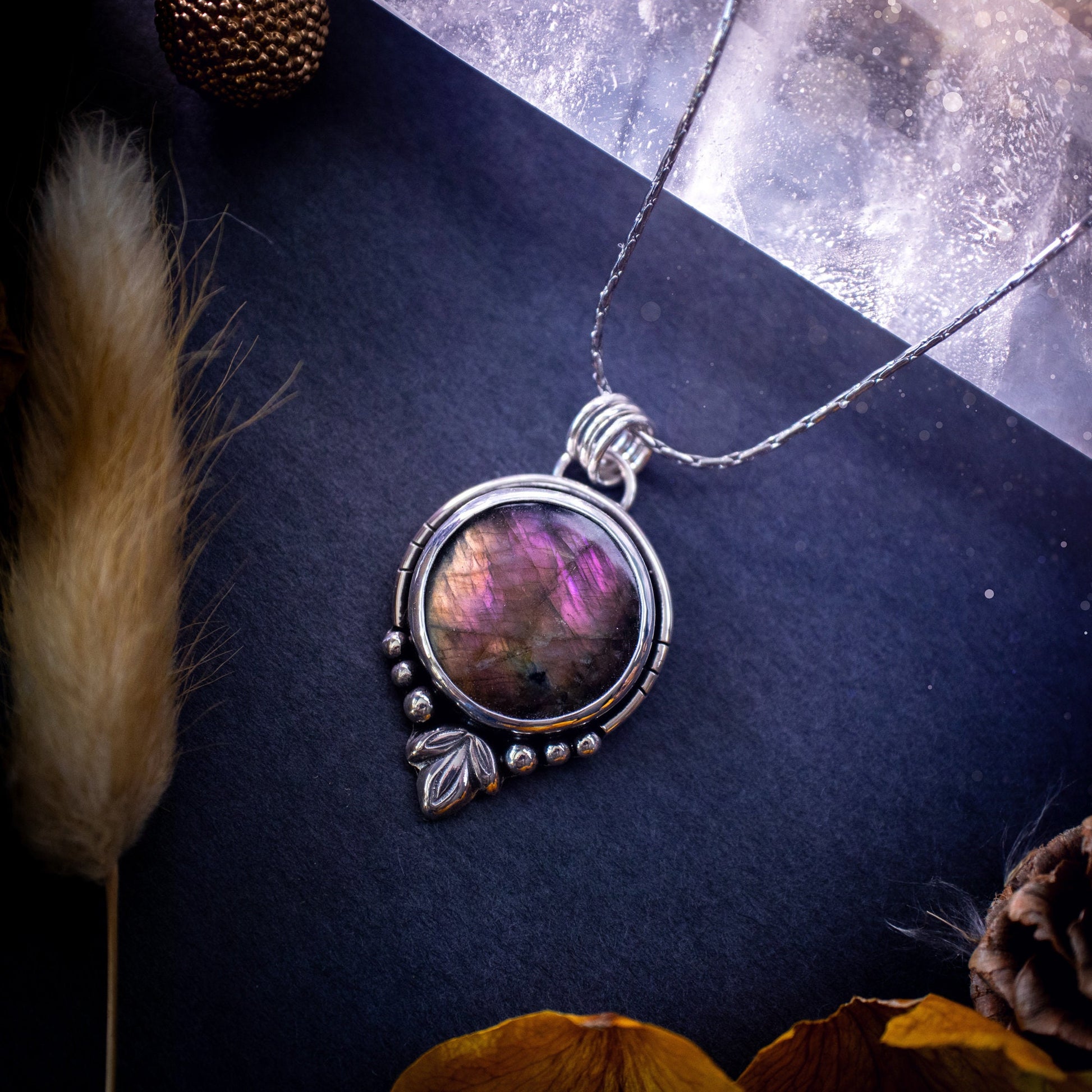 Beautiful and handmade, natural pink, purple and orange labradorite, crystal pendant necklace. This necklace has been made from fine and sterling silver and features silver leaf and ball components. The ideal gift for crystal lovers. Hippy, gothic.