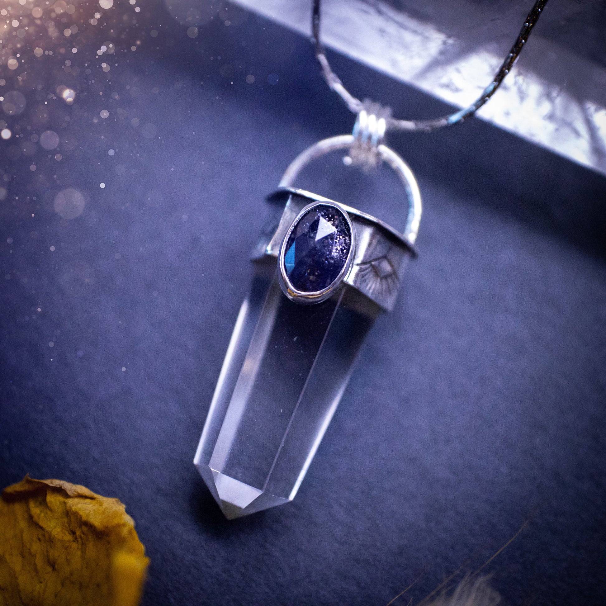 Beautiful, handmade Iolite and quartz crystal point pendant necklace. This pendant is a statement and has been handcrafted out of recycled fine and sterling silver. Featuring southwest stamp detail along the bezel. Ideal for crystal lovers, gothic.