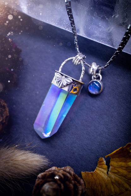 Beautiful, handmade aura quartz crystal point pendant necklace with rainbow moonstone charm. This pendant is a statement and has been handcrafted out of recycled fine and sterling silver. Featuring star stamp detail. Ideal for crystal lovers, gothic