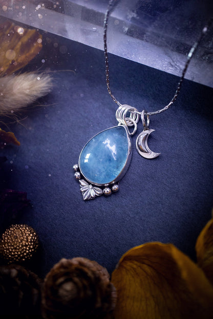 Bold and beautiful, blue aquamarine crystal pendant necklace. This pendant has been handcrafted out of fine and sterling silver. The piece also has a little moon charm. Suitable for jewellery gifts. Gothic, hippy and ideal for her. March birthstone