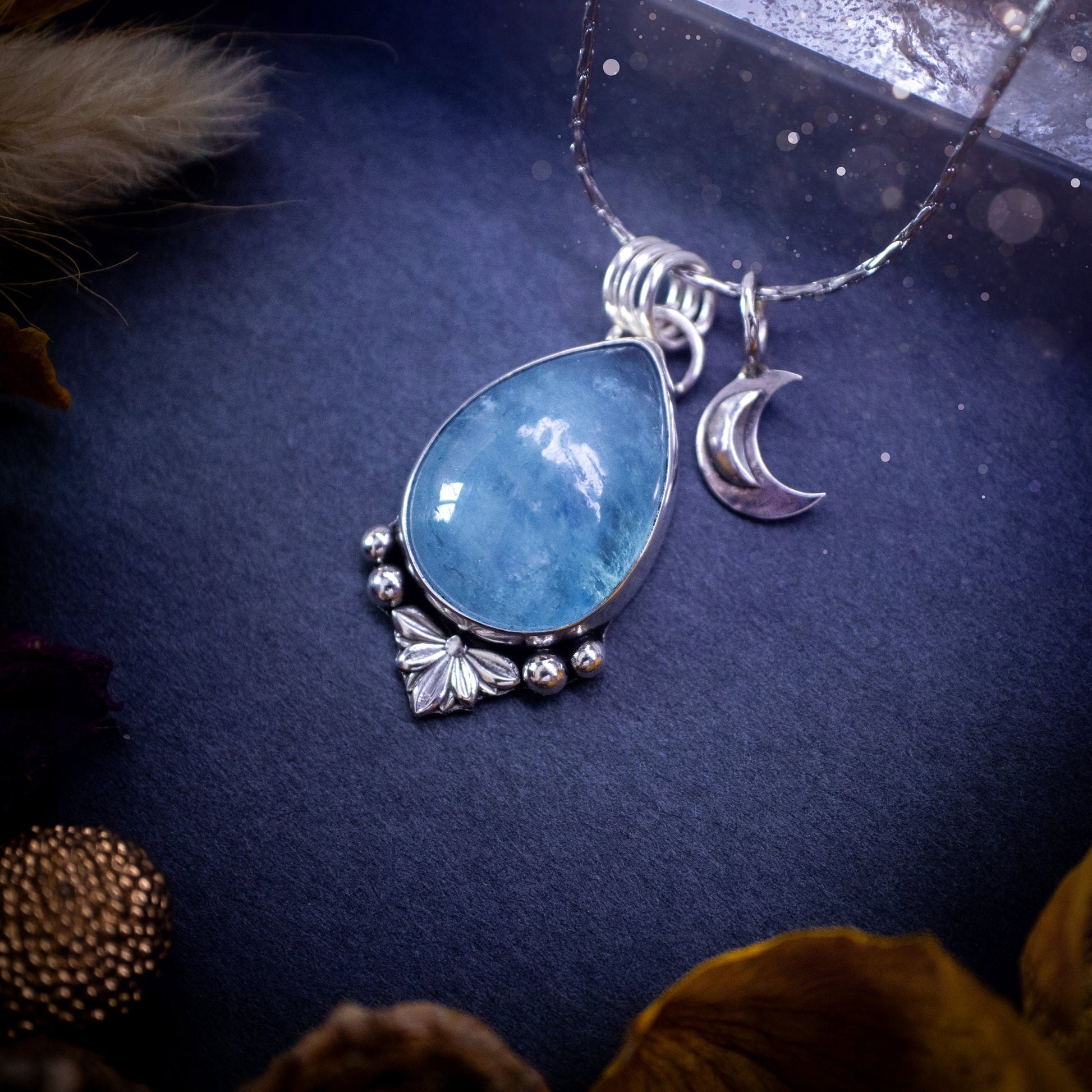 Bold and beautiful, blue aquamarine crystal pendant necklace. This pendant has been handcrafted out of fine and sterling silver. The piece also has a little moon charm. Suitable for jewellery gifts. Gothic, hippy and ideal for her. March birthstone