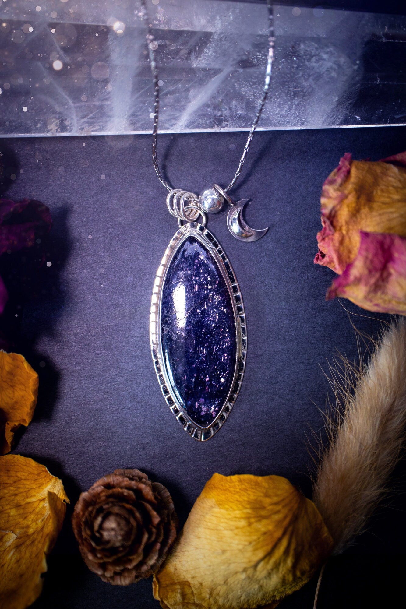 Handcrafted, beautiful, Iolite Sunstone crystal pendant necklace. Featuring a gorgeous sparkly Iolite gemstone, and made from recycled sterling silver. Accompanied by a little moon charm. Ideal gift for crystal and jewellery lovers. Hippy and Gothic