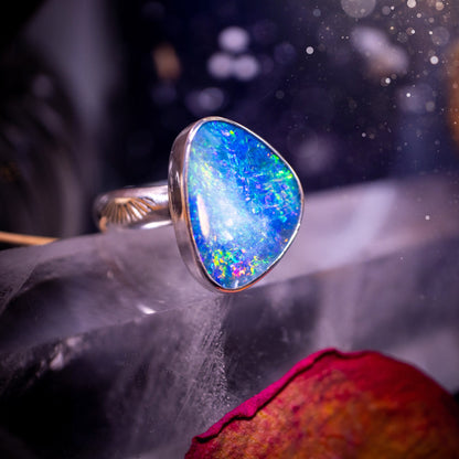 Beautiful and flashy, Australian Opal Doublet ring. Set in sterling and fine silver, this ring will make the ideal gift for that special person. Full of reds, greens, and blues in the natural crystal opal, with stamped ring shank. Size O 1/2