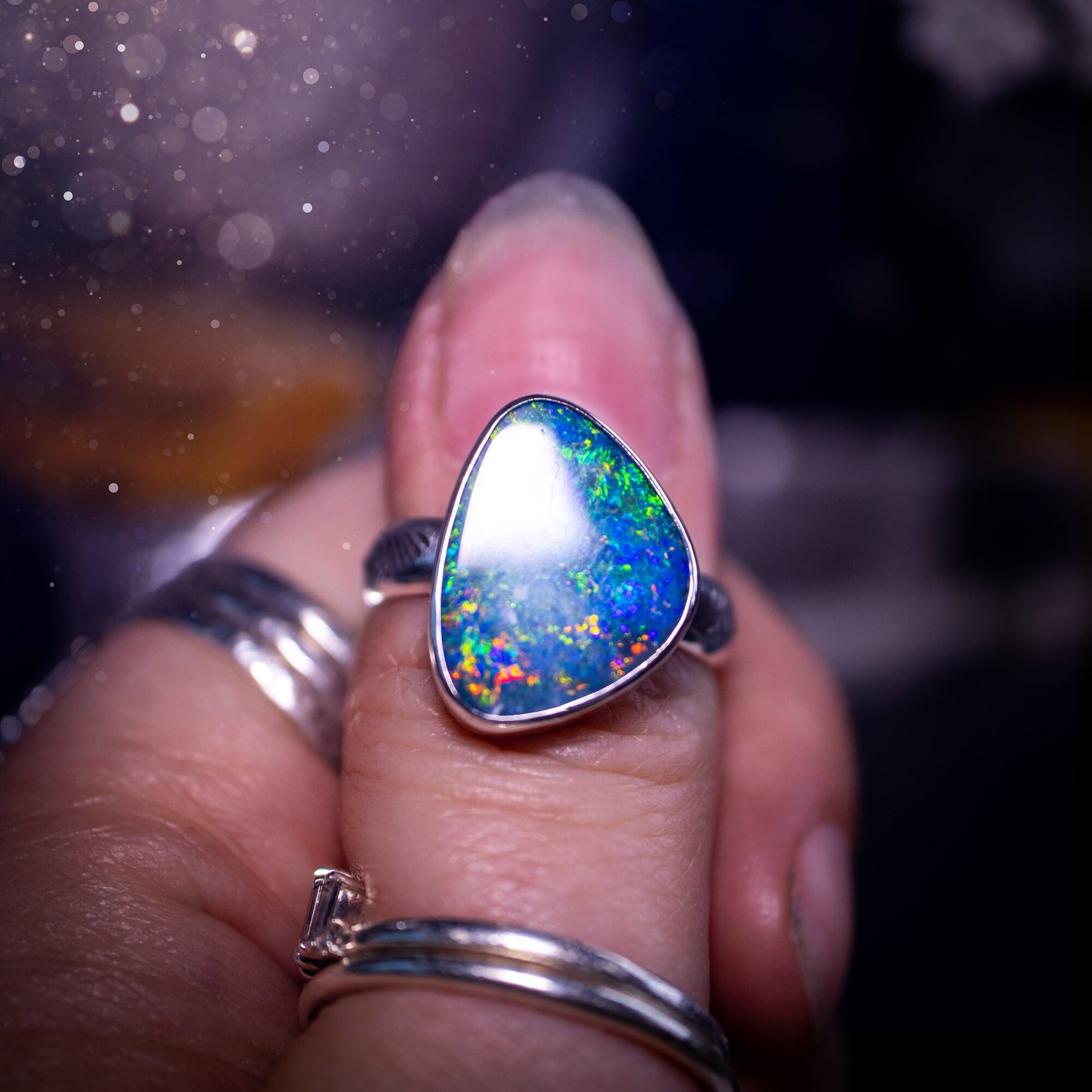 Beautiful and flashy, Australian Opal Doublet ring. Set in sterling and fine silver, this ring will make the ideal gift for that special person. Full of reds, greens, and blues in the natural crystal opal, with stamped ring shank. Size O 1/2