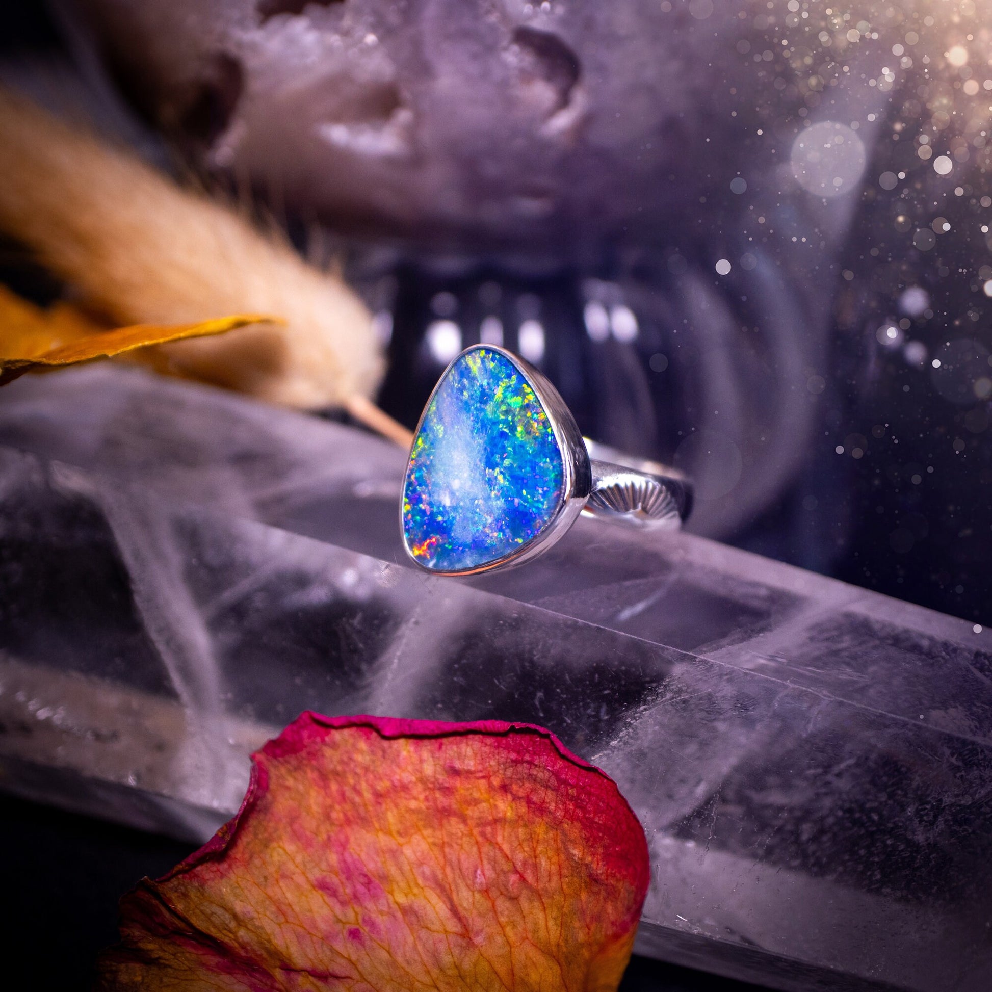 Beautiful and flashy, Australian Opal Doublet ring. Set in sterling and fine silver, this ring will make the ideal gift for that special person. Full of reds, greens, and blues in the natural crystal opal, with stamped ring shank. Size O 1/2