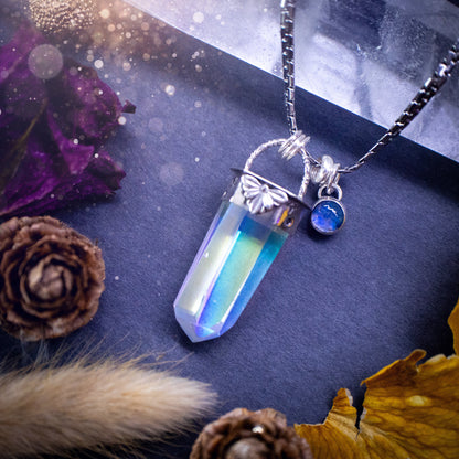 Beautiful, handmade aura quartz crystal point pendant necklace with rainbow moonstone charm. This pendant is a statement and has been handcrafted out of recycled fine and sterling silver. Featuring star stamp detail. Ideal for crystal lovers, gothic