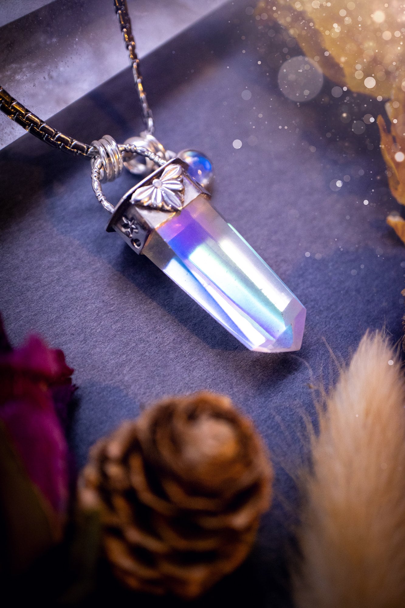 Beautiful, handmade aura quartz crystal point pendant necklace with rainbow moonstone charm. This pendant is a statement and has been handcrafted out of recycled fine and sterling silver. Featuring star stamp detail. Ideal for crystal lovers, gothic