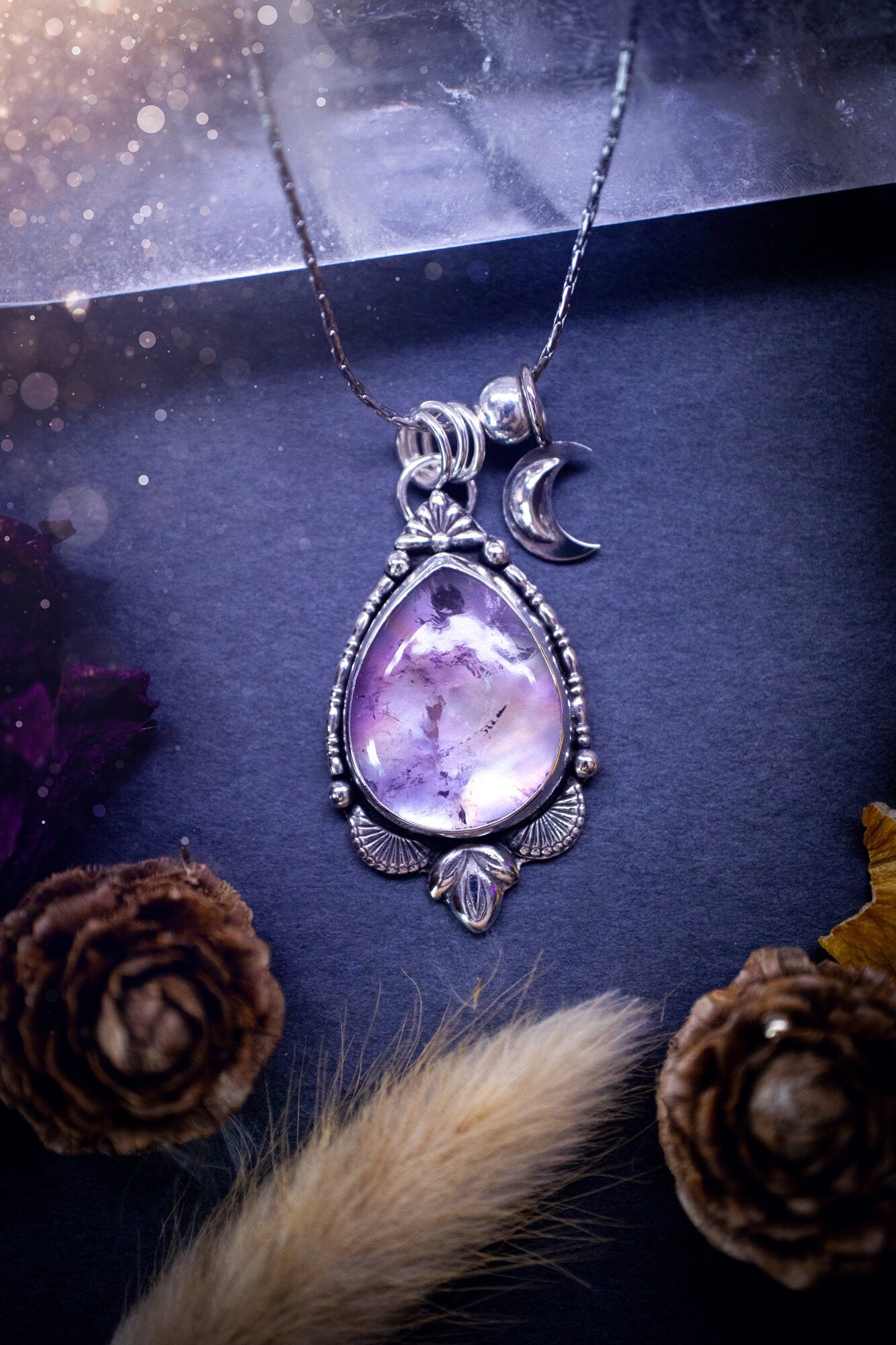 Gorgeous, handcrafted mother of pearl and amethyst doublet crystal pendant necklace. Made from recycled sterling silver. Featuring silver components and beading wire with a little sterling silver moon charm. Ideal for jewellery and crystal lovers.