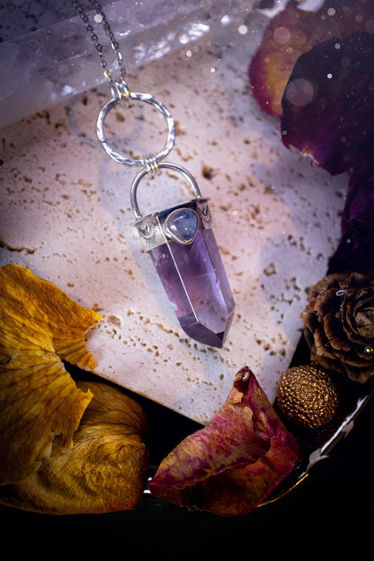 Beautifully handcrafted smoky phantom amethyst pointed pendant necklace. Featuring a small and flashy rainbow moonstone on the bezel which has been made from recycled sterling silver. Gorgeous inclusions in the amethyst. Ideal crystal gifts for her.