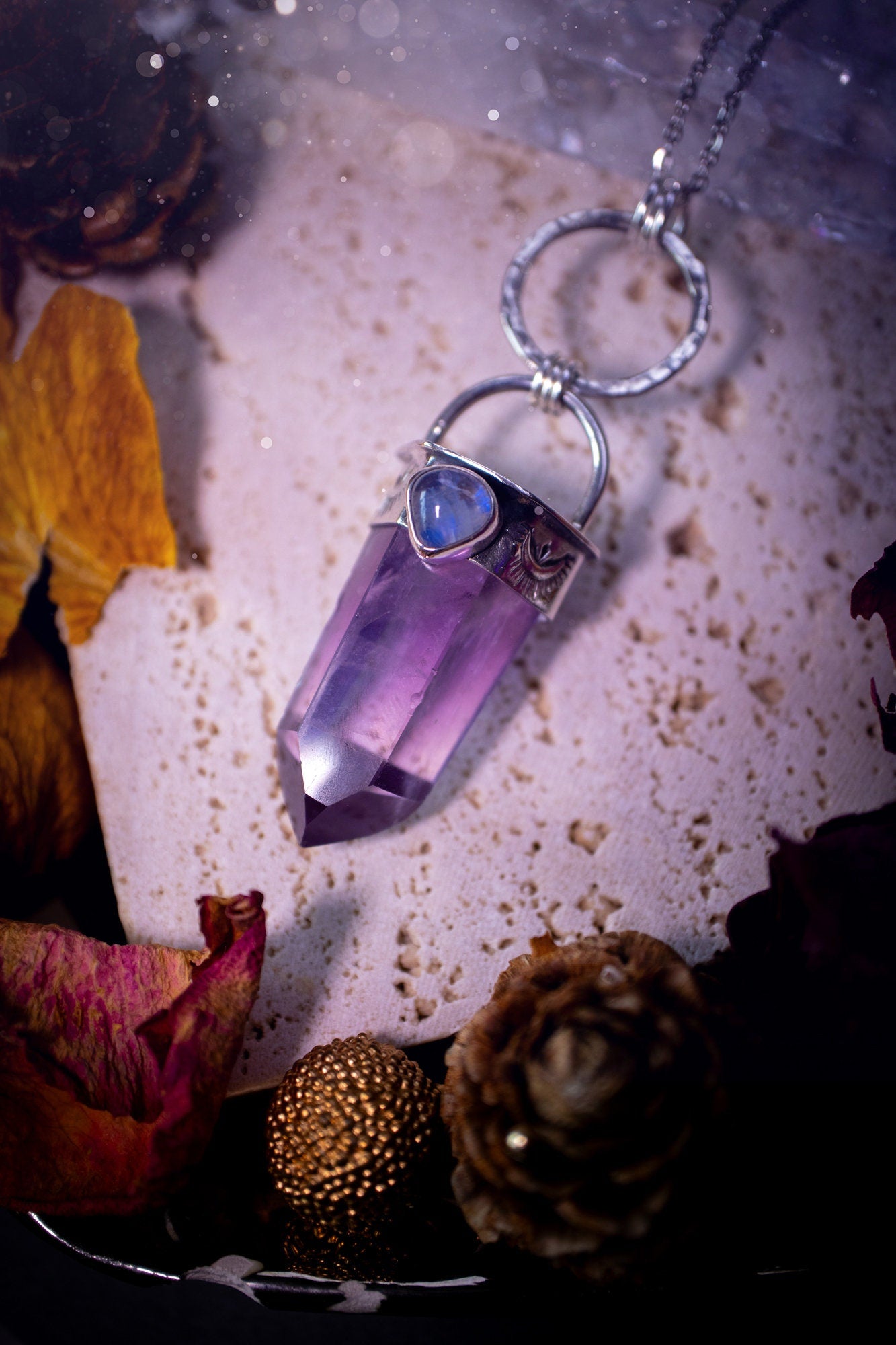 Beautifully handcrafted smoky phantom amethyst pointed pendant necklace. Featuring a small and flashy rainbow moonstone on the bezel which has been made from recycled sterling silver. Gorgeous inclusions in the amethyst. Ideal crystal gifts for her.