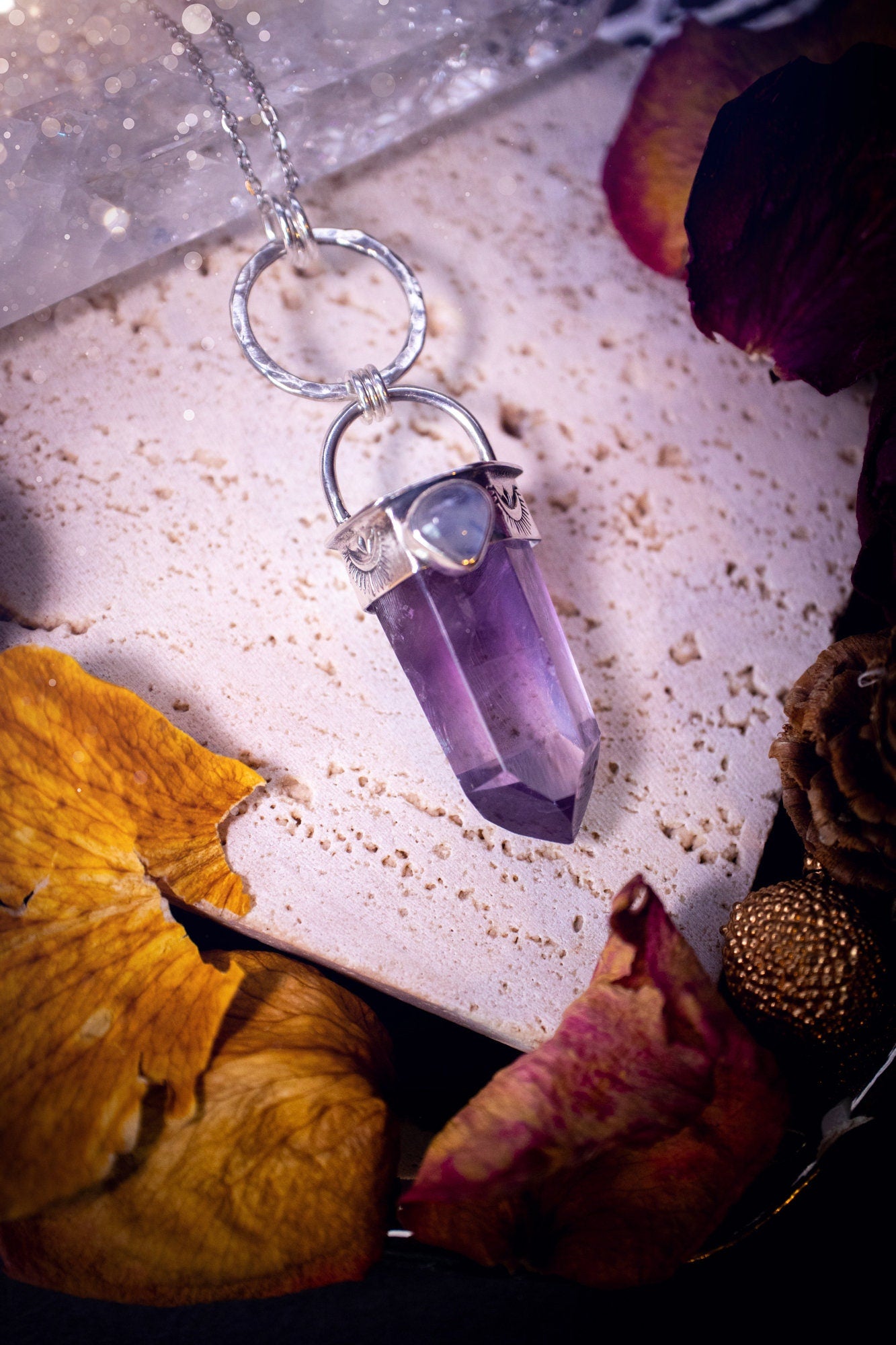 Beautifully handcrafted smoky phantom amethyst pointed pendant necklace. Featuring a small and flashy rainbow moonstone on the bezel which has been made from recycled sterling silver. Gorgeous inclusions in the amethyst. Ideal crystal gifts for her.