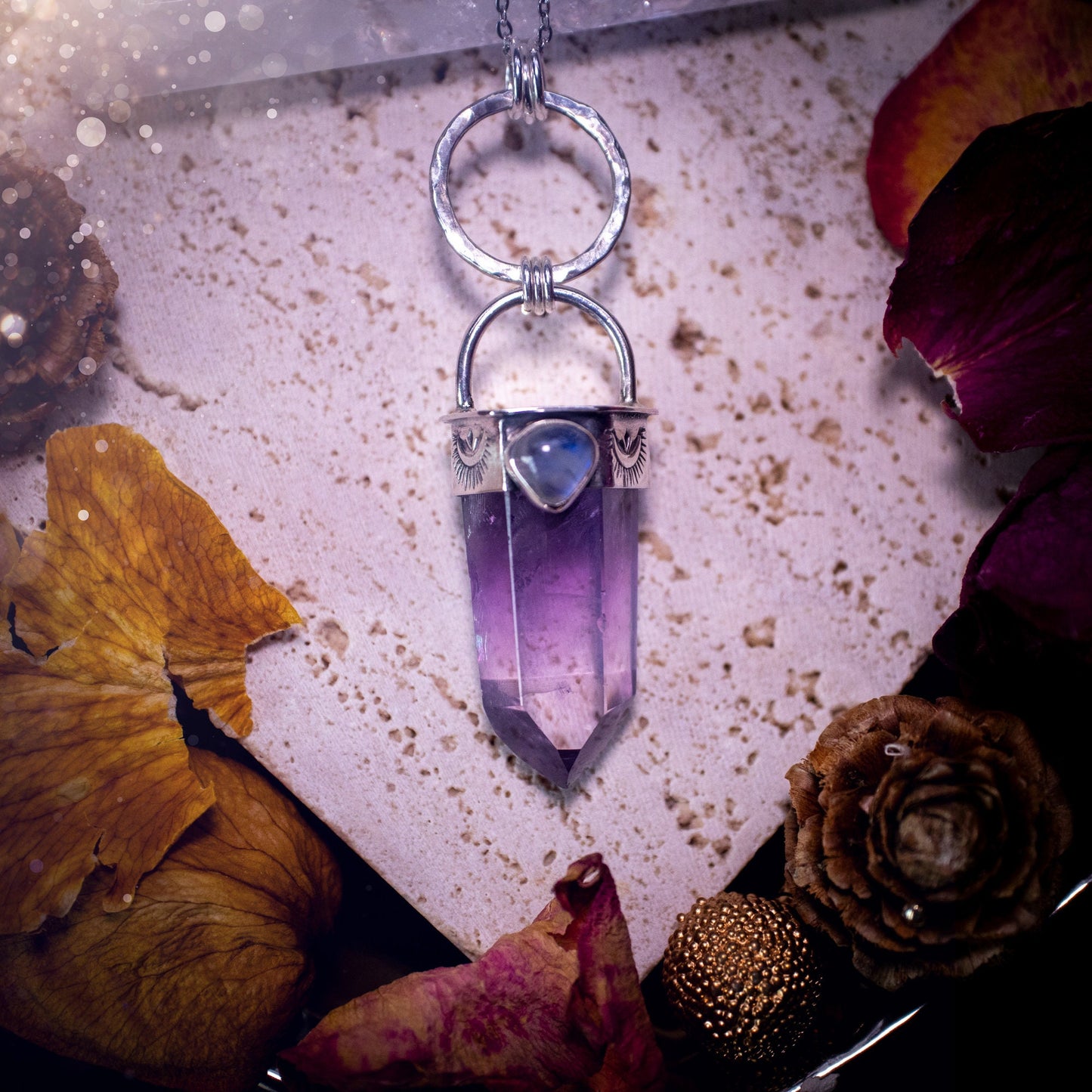 Beautifully handcrafted smoky phantom amethyst pointed pendant necklace. Featuring a small and flashy rainbow moonstone on the bezel which has been made from recycled sterling silver. Gorgeous inclusions in the amethyst. Ideal crystal gifts for her.