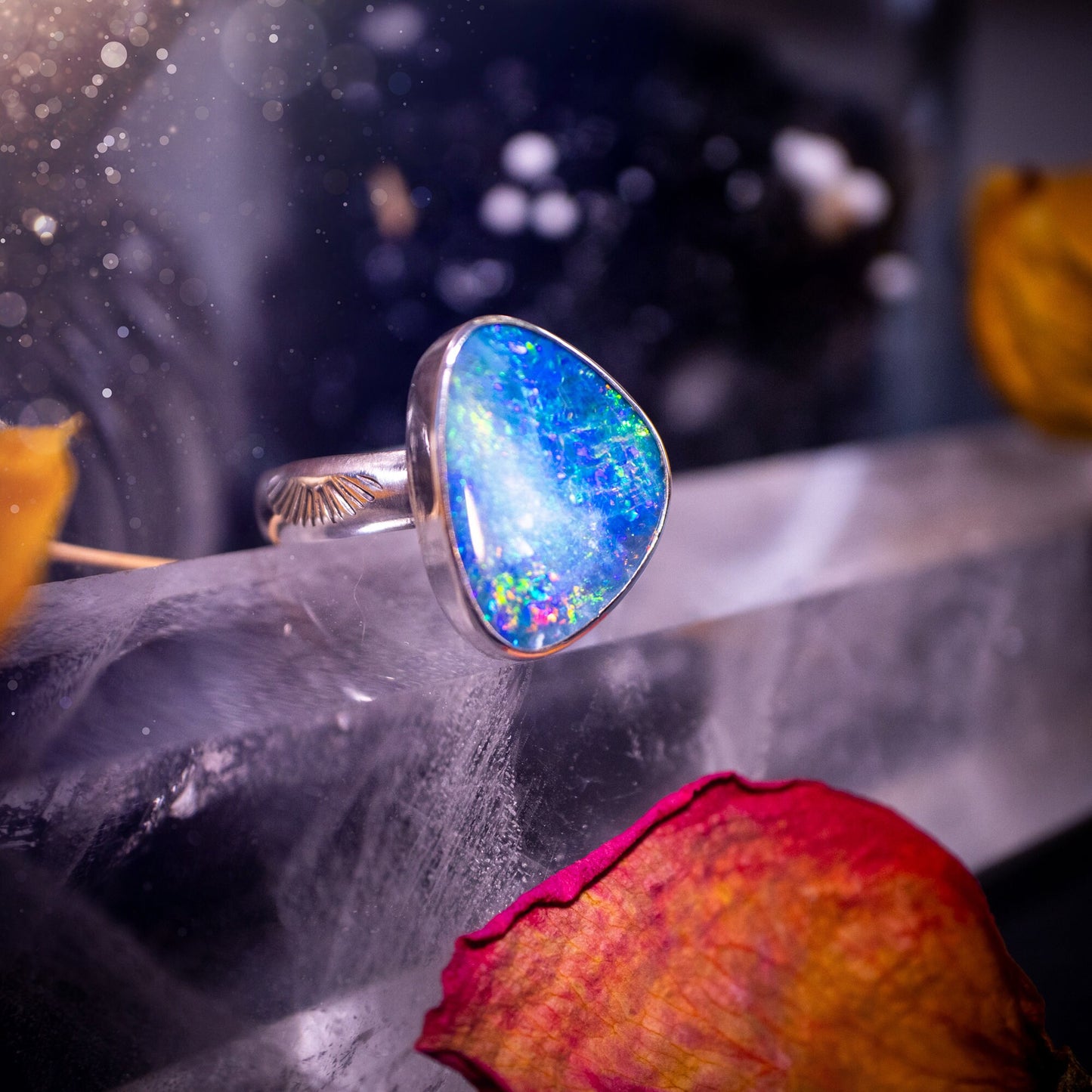 Beautiful and flashy, Australian Opal Doublet ring. Set in sterling and fine silver, this ring will make the ideal gift for that special person. Full of reds, greens, and blues in the natural crystal opal, with stamped ring shank. Size O 1/2