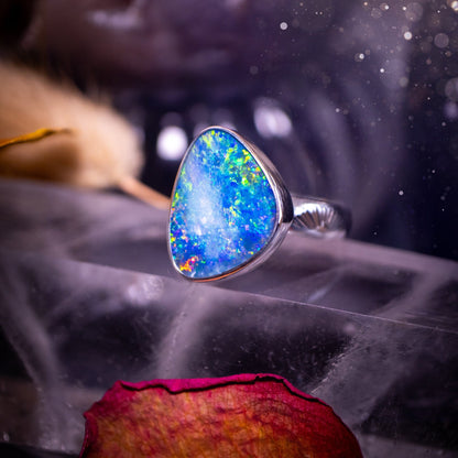 Beautiful and flashy, Australian Opal Doublet ring. Set in sterling and fine silver, this ring will make the ideal gift for that special person. Full of reds, greens, and blues in the natural crystal opal, with stamped ring shank. Size O 1/2