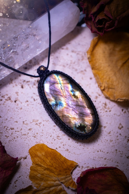 Handcrafted, purple and pink, labradorite spectrolite pendant necklace. This piece of jewellery features a fairy tale crystal full of magical colours. Has been handmade using high quality Linhasita cord. Ideal gift for hippies and crystal lovers.