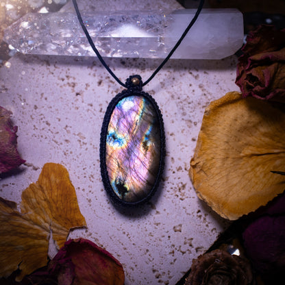 Handcrafted, purple and pink, labradorite spectrolite pendant necklace. This piece of jewellery features a fairy tale crystal full of magical colours. Has been handmade using high quality Linhasita cord. Ideal gift for hippies and crystal lovers.