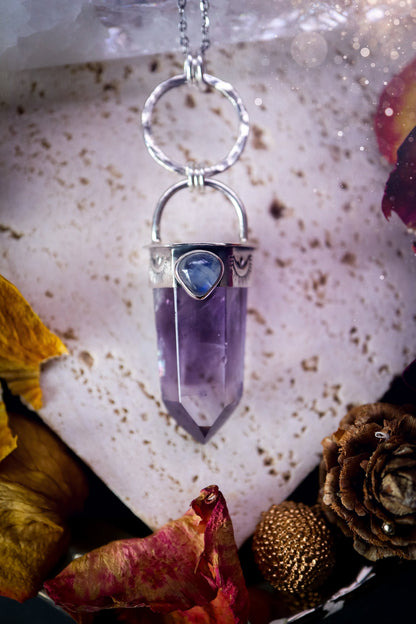 Beautifully handcrafted smoky phantom amethyst pointed pendant necklace. Featuring a small and flashy rainbow moonstone on the bezel which has been made from recycled sterling silver. Gorgeous inclusions in the amethyst. Ideal crystal gifts for her.