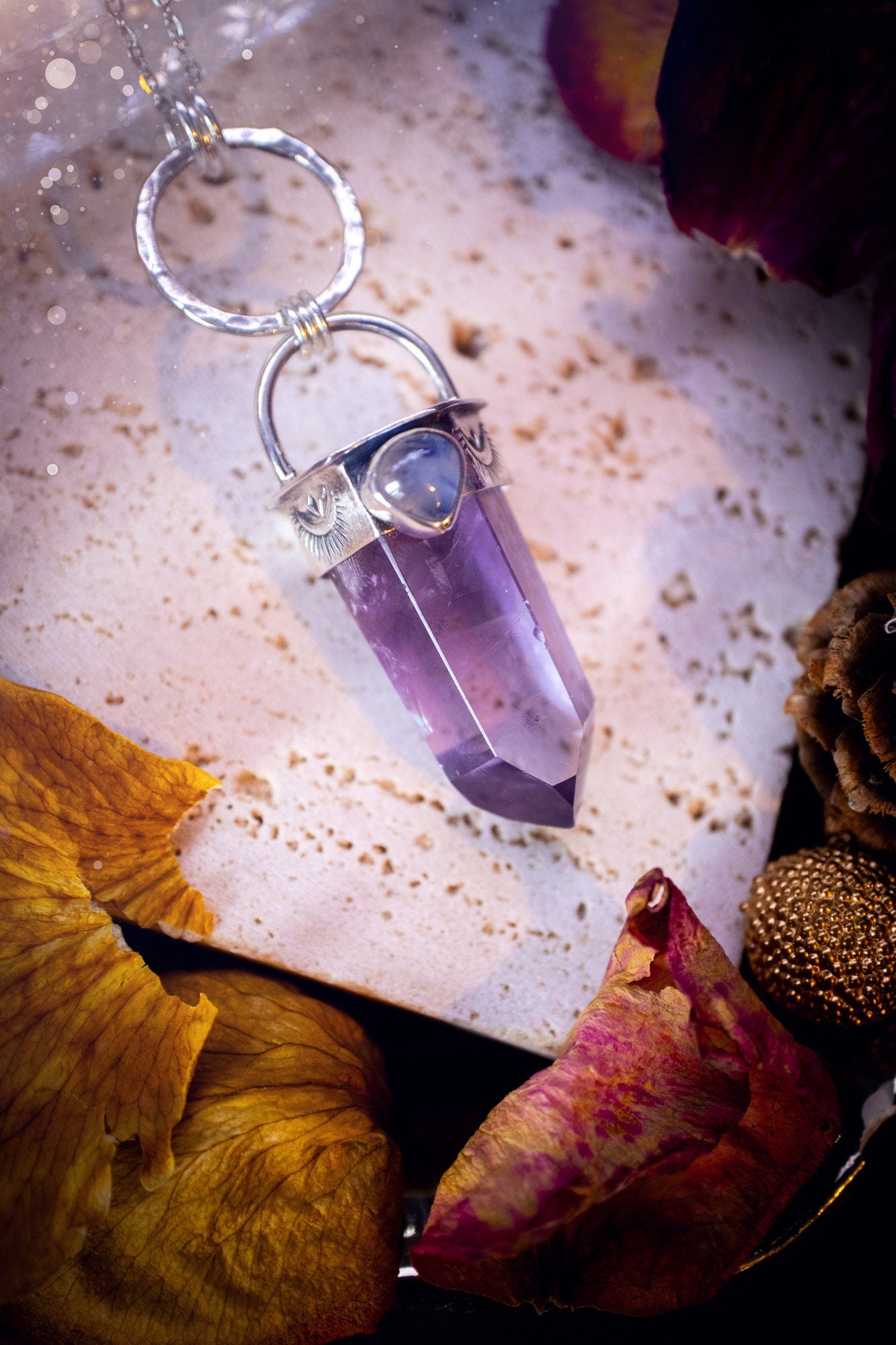 Beautifully handcrafted smoky phantom amethyst pointed pendant necklace. Featuring a small and flashy rainbow moonstone on the bezel which has been made from recycled sterling silver. Gorgeous inclusions in the amethyst. Ideal crystal gifts for her.