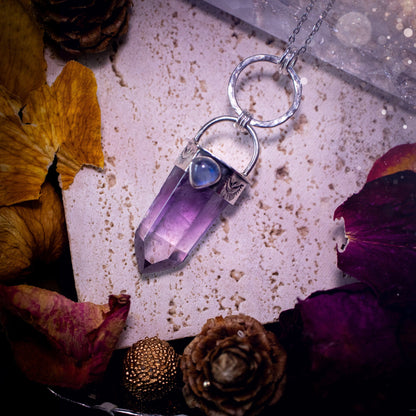 Beautifully handcrafted smoky phantom amethyst pointed pendant necklace. Featuring a small and flashy rainbow moonstone on the bezel which has been made from recycled sterling silver. Gorgeous inclusions in the amethyst. Ideal crystal gifts for her.