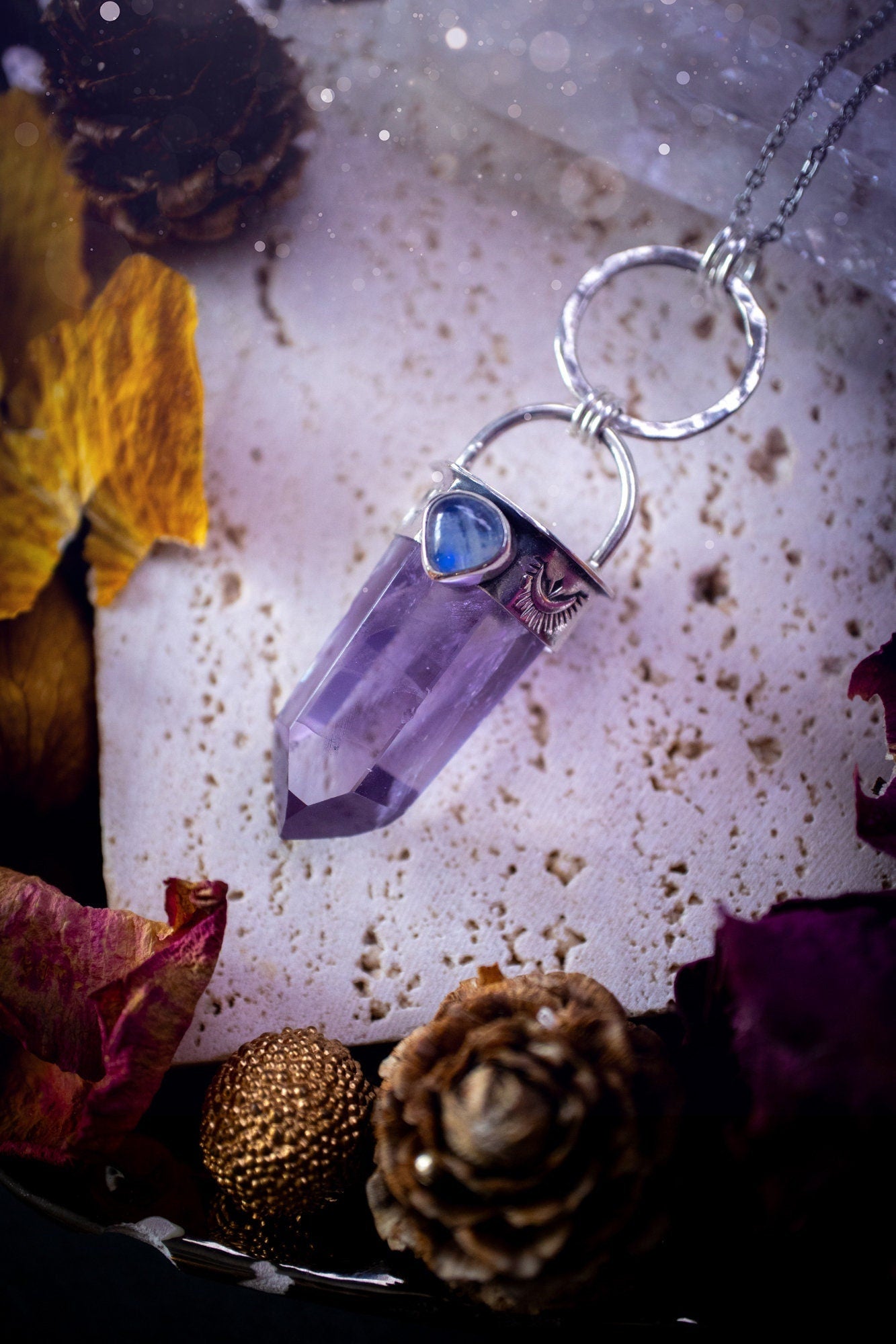 Beautifully handcrafted smoky phantom amethyst pointed pendant necklace. Featuring a small and flashy rainbow moonstone on the bezel which has been made from recycled sterling silver. Gorgeous inclusions in the amethyst. Ideal crystal gifts for her.