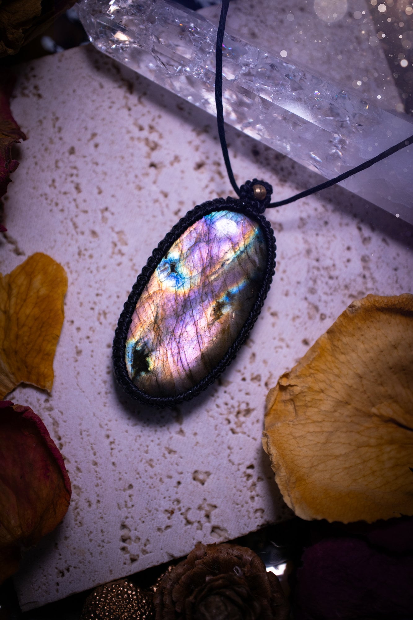 Handcrafted, purple and pink, labradorite spectrolite pendant necklace. This piece of jewellery features a fairy tale crystal full of magical colours. Has been handmade using high quality Linhasita cord. Ideal gift for hippies and crystal lovers.