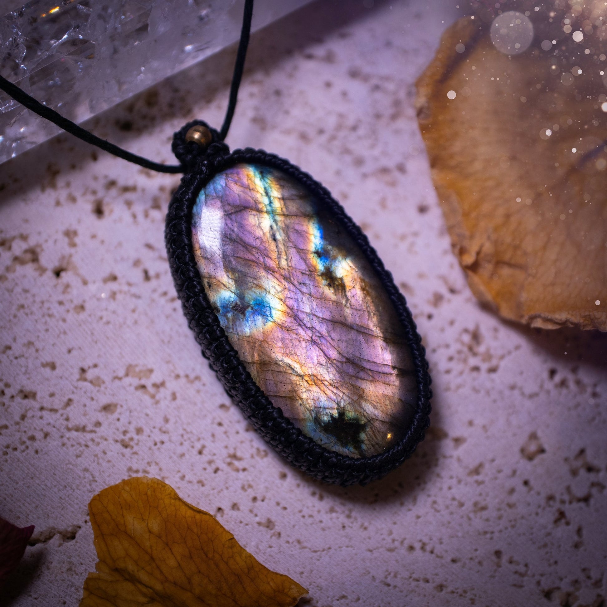 Handcrafted, purple and pink, labradorite spectrolite pendant necklace. This piece of jewellery features a fairy tale crystal full of magical colours. Has been handmade using high quality Linhasita cord. Ideal gift for hippies and crystal lovers.