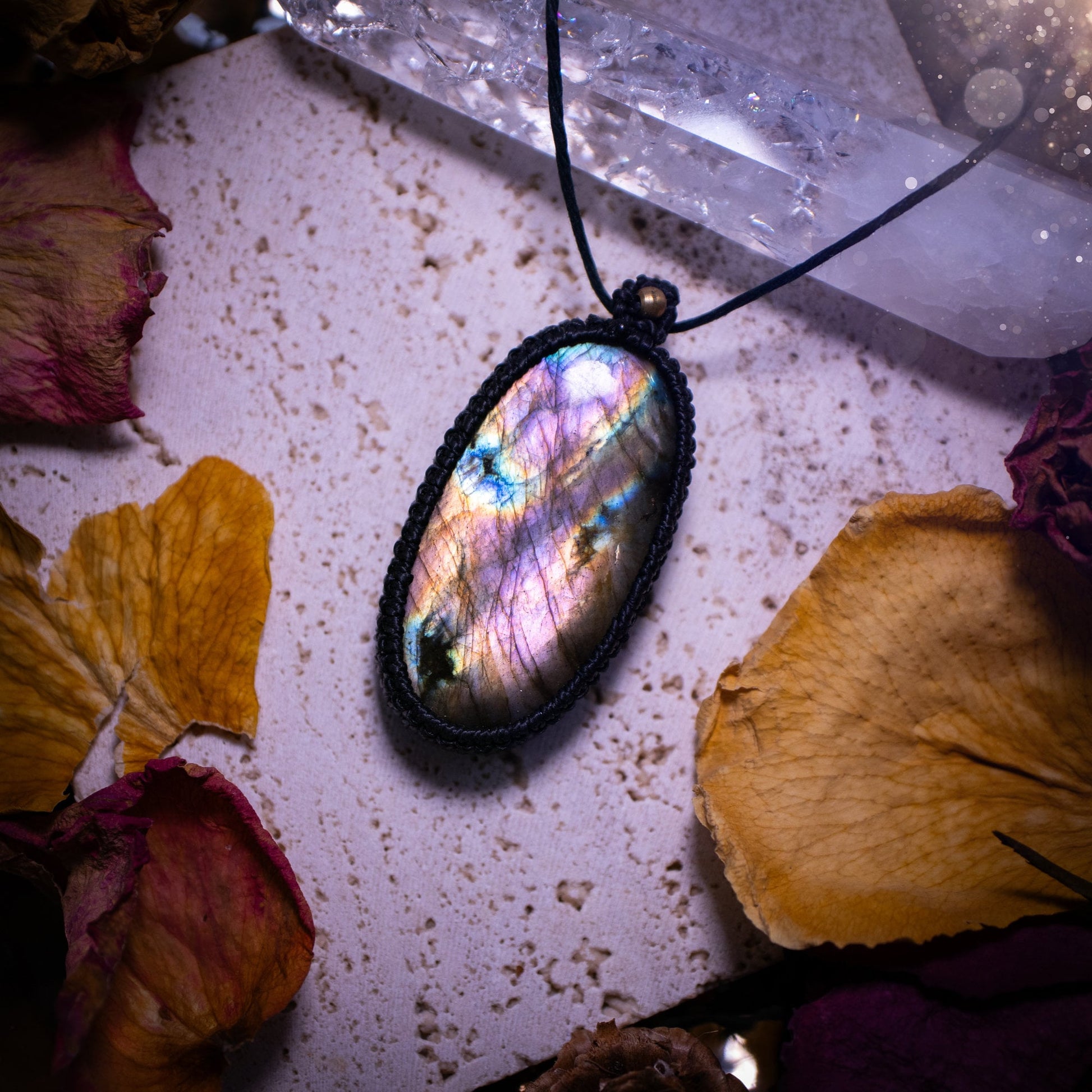 Handcrafted, purple and pink, labradorite spectrolite pendant necklace. This piece of jewellery features a fairy tale crystal full of magical colours. Has been handmade using high quality Linhasita cord. Ideal gift for hippies and crystal lovers.