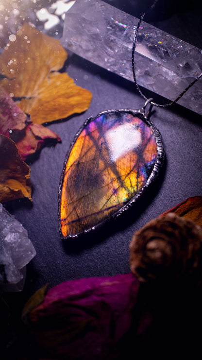 Beautiful, orange, pink and purple labradorite crystal which has been soft soldered to create a stunning pendant. Natural crystal gemstone with lead free solder, a beautiful gift for any crystal lover. This piece of jewellery can be used for healing