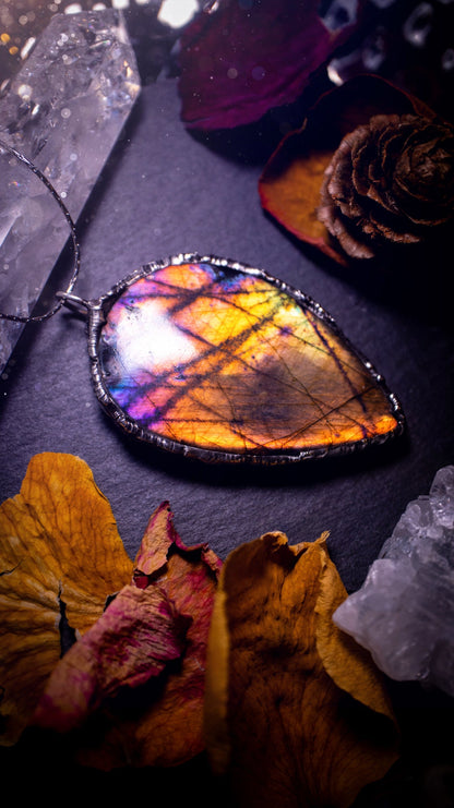 Beautiful, orange, pink and purple labradorite crystal which has been soft soldered to create a stunning pendant. Natural crystal gemstone with lead free solder, a beautiful gift for any crystal lover. This piece of jewellery can be used for healing