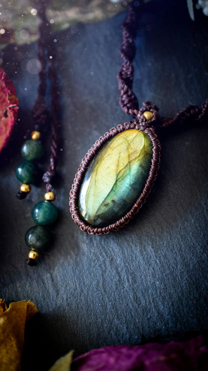 Handmade, autumn green coloured labradorite macrame pendant necklace. Featuring a beautiful labradorite crystal which is full of orange, yellow and purple colours. Crafted with high quality linhastia wax cord, and accents on the necklace. Hippy gifts