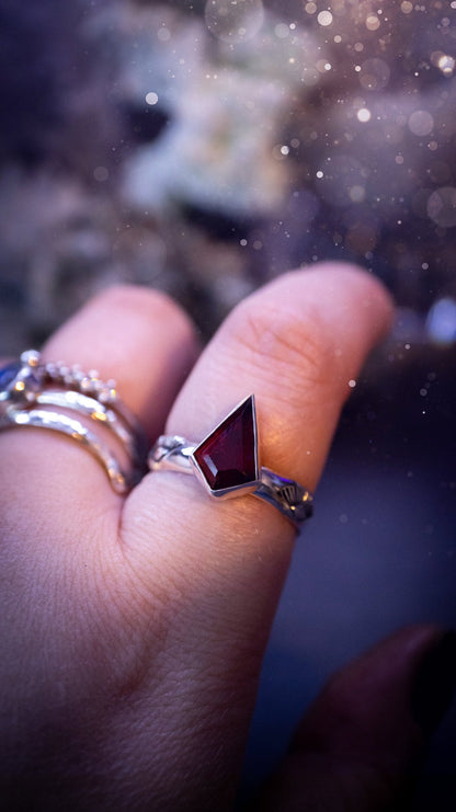 Beautiful and bold, garnet statement ring. Although this ring is dainty, it will certainly make a statement. Featuring a lovely red garnet crystal which is step cut, and mounted in sterling silver on a stamped ring band. Ideal crystal gifts for her