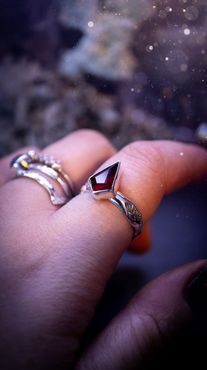 Beautiful and bold, garnet statement ring. Although this ring is dainty, it will certainly make a statement. Featuring a lovely red garnet crystal which is step cut, and mounted in sterling silver on a stamped ring band. Ideal crystal gifts for her