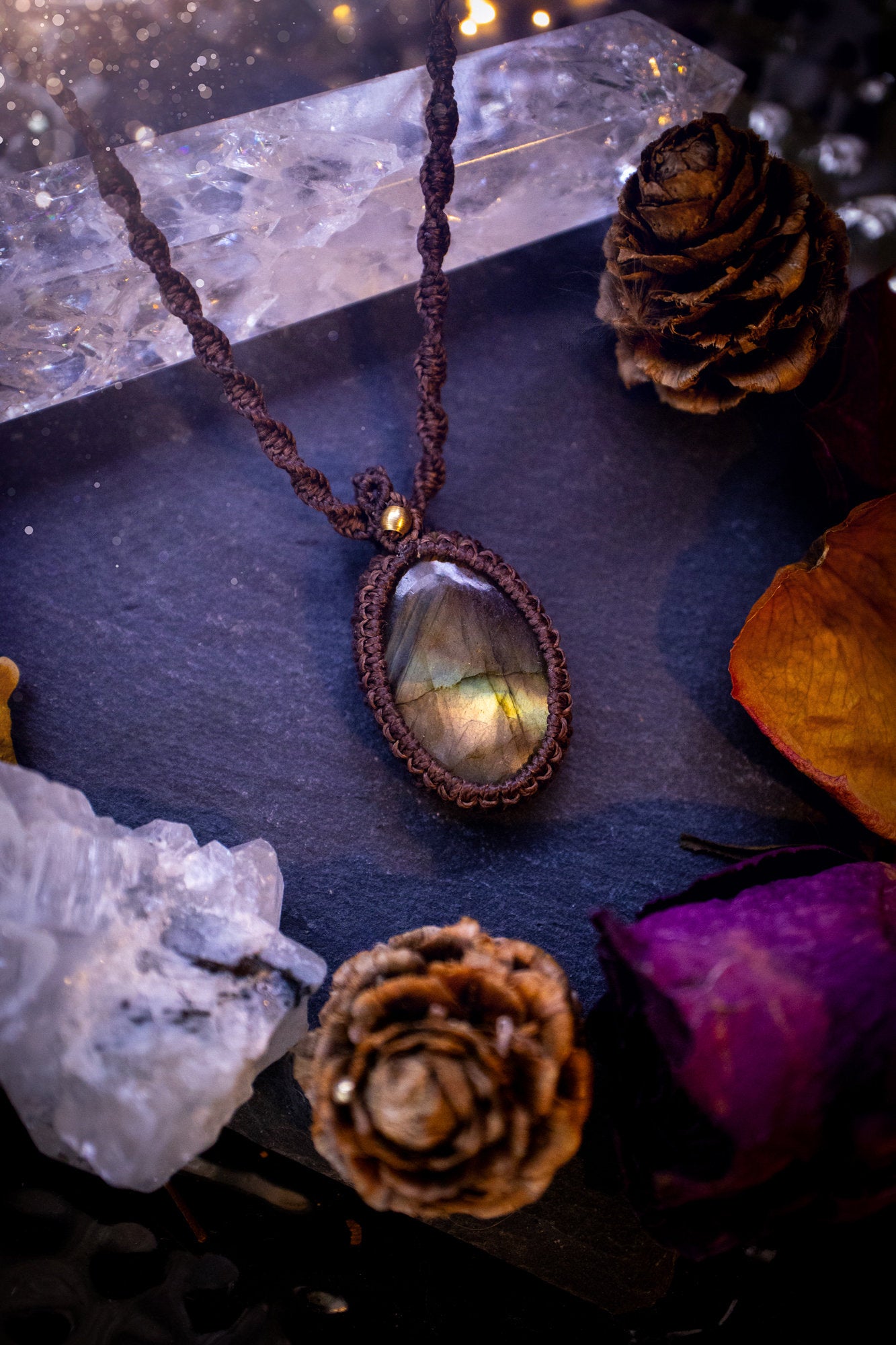 Handmade, autumn coloured labradorite macrame pendant necklace. Featuring a beautiful labradorite crystal which is full of orange, yellow and purple colours. Crafted with high quality linhastia wax cord, and accents on the necklace. Hippy gifts